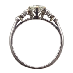 Platinum single stone diamond ring, with four diamonds set either side, stamped PLAT, central diamond approx 0.80 carat