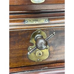 The Shannon Limited - late Victorian walnut filing cabinet, fitted with twenty-four small filing drawers, each with brass handle with label holder, fluted uprights, double cupboard below enclosed by two panelled doors, on turned feet, with brass plaque inscribed 'The Shannon, Limited, Ropemaker St. London, E.C.'