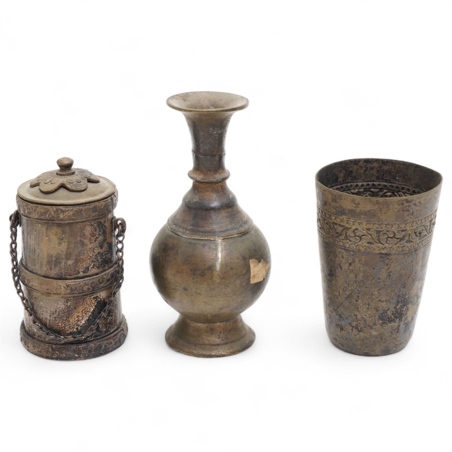 Three Chinese red and black cinnabar lacquered vases, together with three metalware examples, possibly 19th century Islamic, comprising vase, cup and covered vessel with floral handle; and a carved soapstone pig (7)