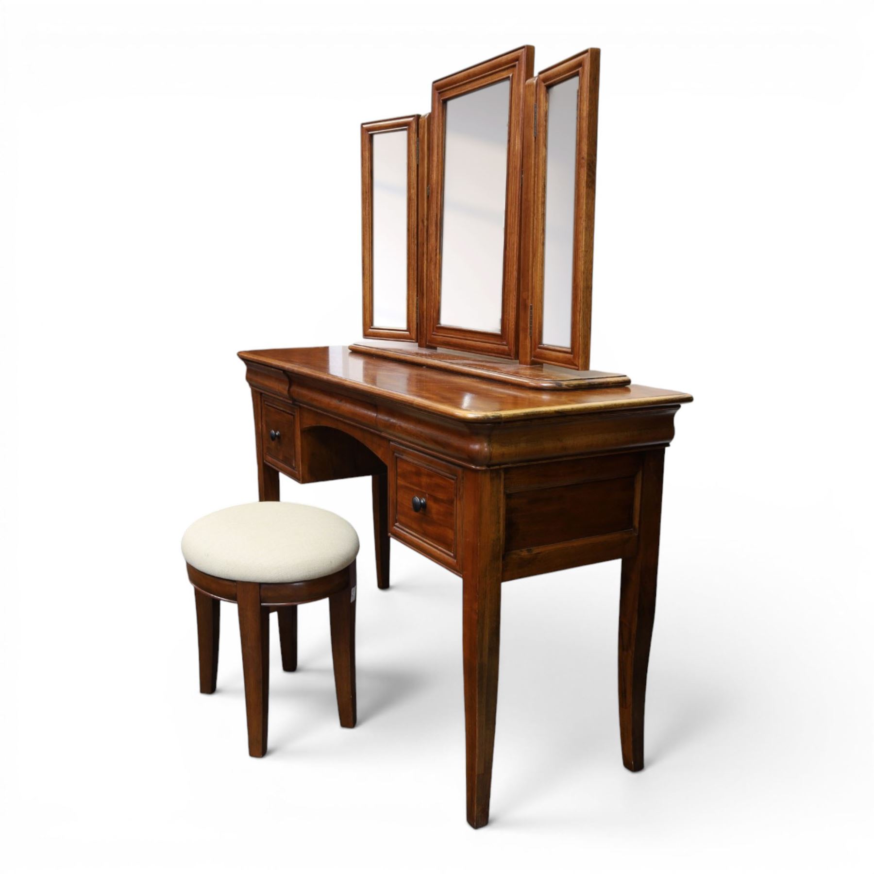 Willis & Gambier - mahogany dressing table, three part mirror and stool, the dressing table with rectangular top with chamfered corners, over two baize lined frieze drawers, kneehole recess and a single drawer either side, three part mirror with central tilting mirror on a moulded plinth base, with oval beige padded stool 