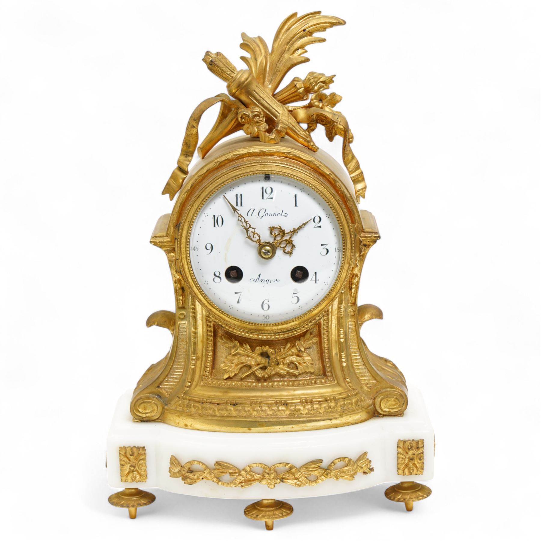 French-Ormolu and white marble mantle clock with garnitures, c 1910, with a white enamel dial and Arabic numerals, indistinct signature, pierced gilt-metal hands and minute markers, 8-day twin train countwheel striking movement, sounding the hours and half-hours on a bell, with a matching pair of two light candelabra. With pendulum and key.
