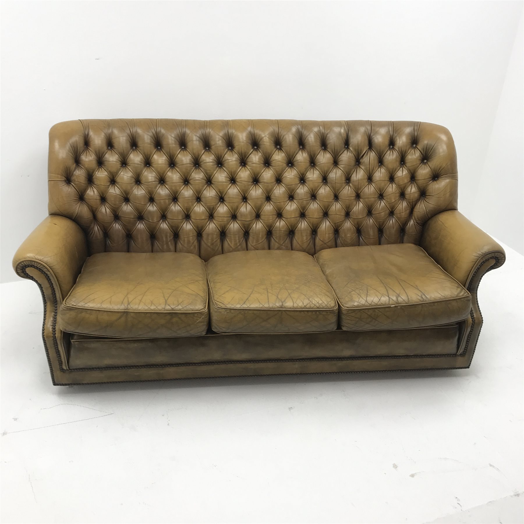 Pegasus three seat sofa upholstered in deeply buttoned antique brown leather, W185cm