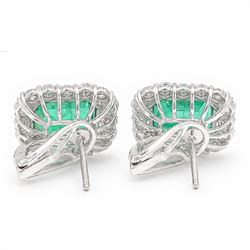 Pair of 18ct white gold emerald and diamond cluster earrings, each stud set with a single octagonal cut emerald and surrounded by sixteen round brilliant cut diamonds, stamped 750, total emerald weight approx 6.90 carat, total diamond weight approx 1.90 carat