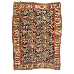 Persian Bidjar indigo ground rug, the busy field decorated with large floral motifs, the guarded ivory border adorned with repeating flower heads and stylised leaves