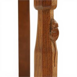 Mouseman - oak panel back carver armchair, lightly adzed panel back above a tan seat with brass studded trim, flanked by swept arms raised on octagonal front supports, with carved mouse signature, by the workshop of Robert Thompson of Kilburn