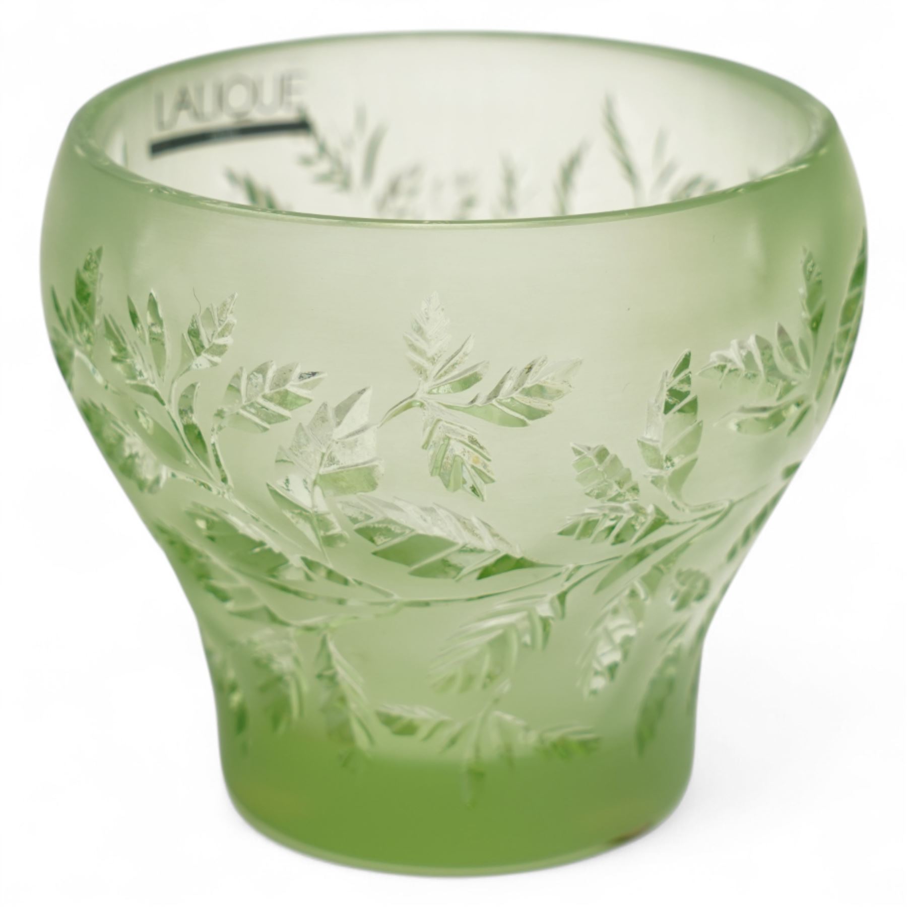 Lalique green glass tea light holder decorated with the coriandre pattern H8cm, another in the basil pattern H8cm and another with trailing leaves H8cm, all signed 'Lalique, France'