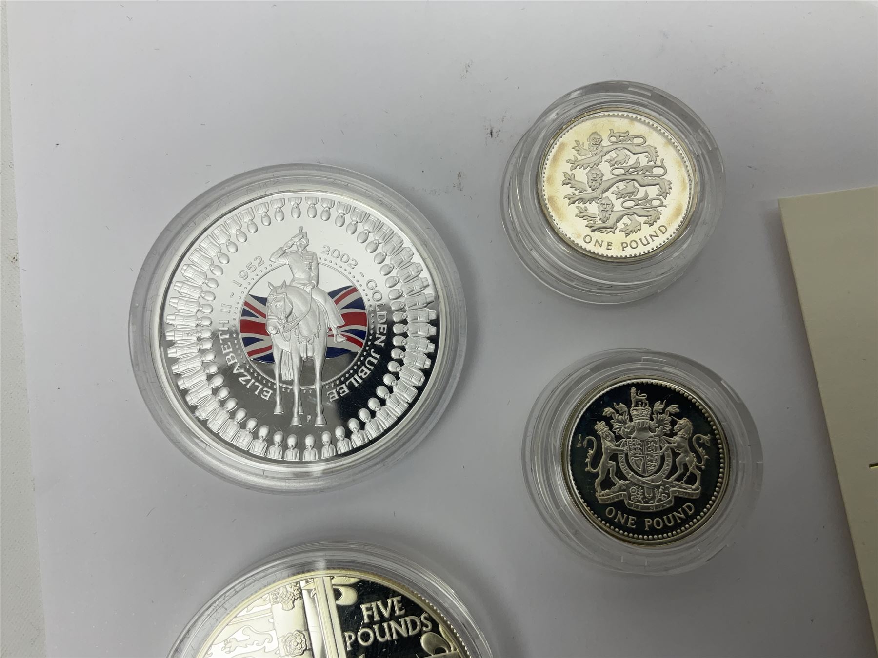 Thirteen silver coins, including Queen Elizabeth II Solomon Islands 2002 sterling silver five dollars, Alderney 2002 sterling silver five pounds, Fiji 2002 sterling silver ten dollars, United Kingdom 2003 one ounce fine silver Britannia, 2003 'Give Women The Vote' fifty pence etc, all with some form of certificate