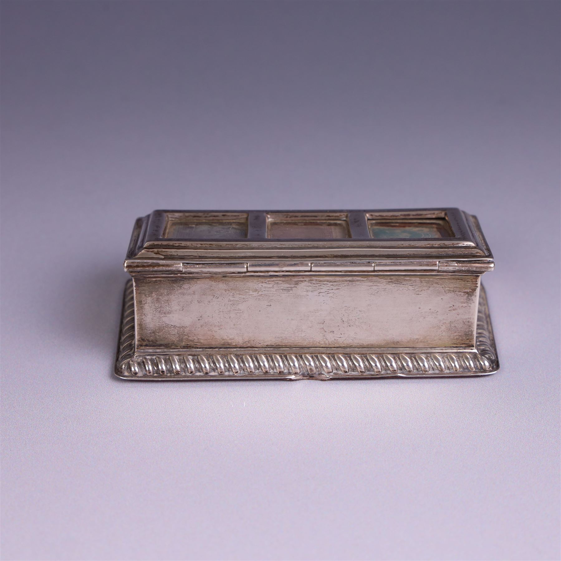 Late Victorian silver mounted stamp box, the hinged lid with three glazed panels, hallmarked Grey & Co, London 1900, together with a late Victorian silver hair comb and a cased set of six silver coffee spoons