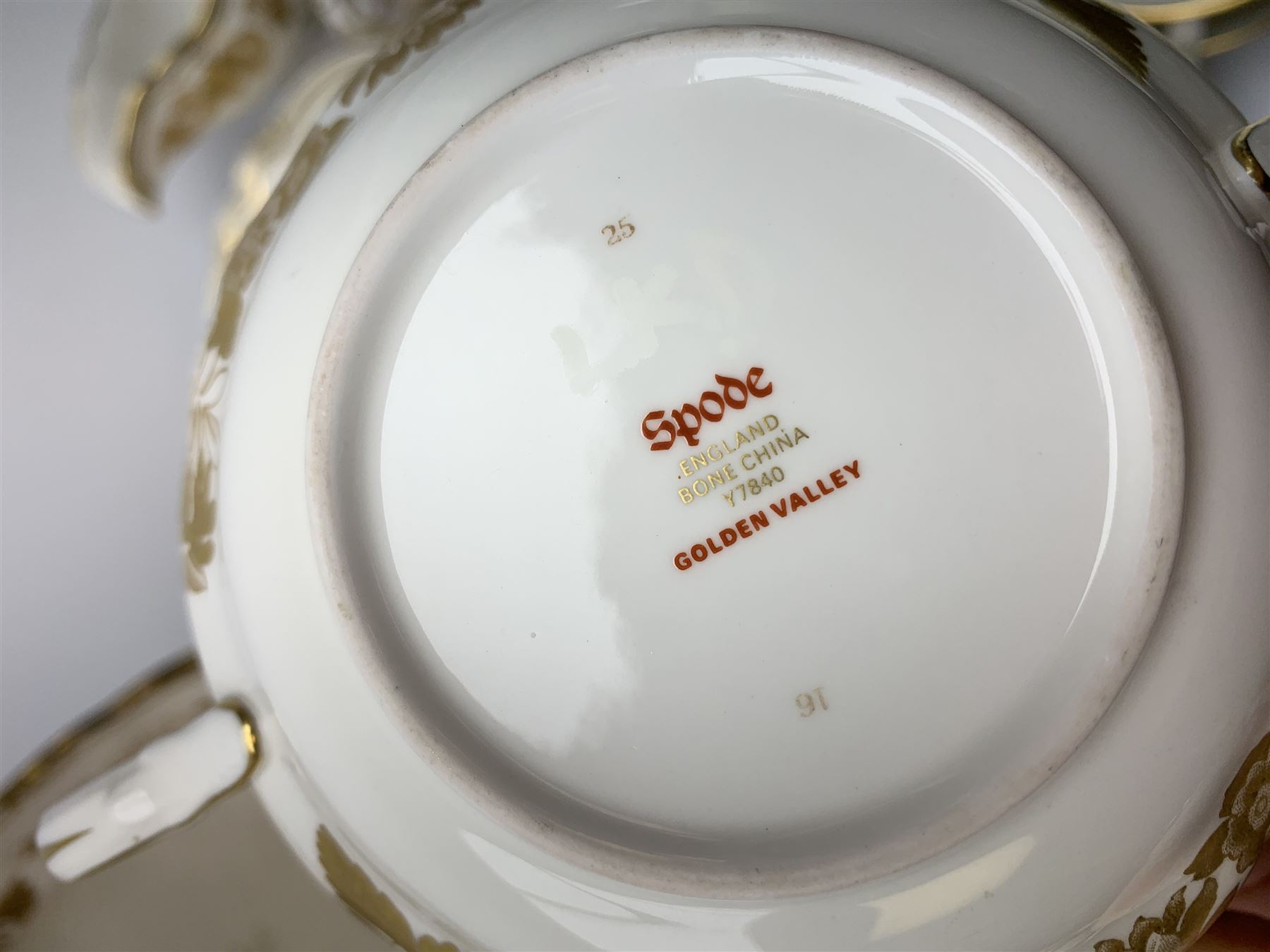 Extensive Spode dinner and tea service, decorated in the Golden Valley pattern, comprising eighteen dinner plates, ten salad plates, ten side plates, ten twin handled soup bowls and ten saucers, ten bowls, two sauce boats and two stands, two square serving dishes, smaller oval serving dish, two tureens and covers, two large oval serving platters, one smaller example, teapot, coffee pot, milk jug, twin handled lidded sucrier, and ten teacups and ten saucers, with red printed marks beneath 