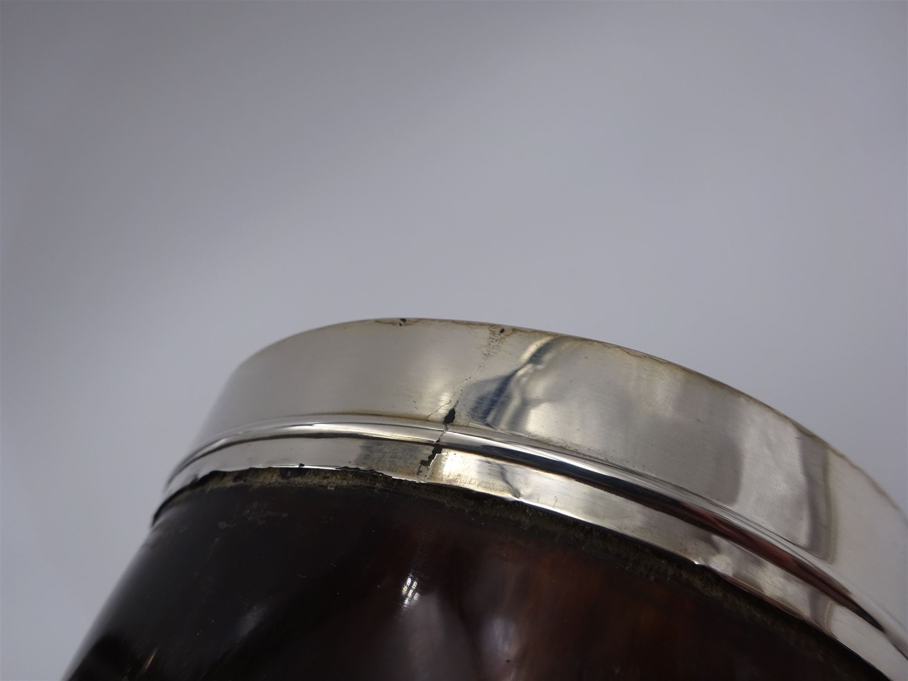 George III silver mounted horn cup, of tapering circular form, with polished exterior, the silver mounted collar hallmarked London 1808, no visible assay or makers mark, H13.5cm