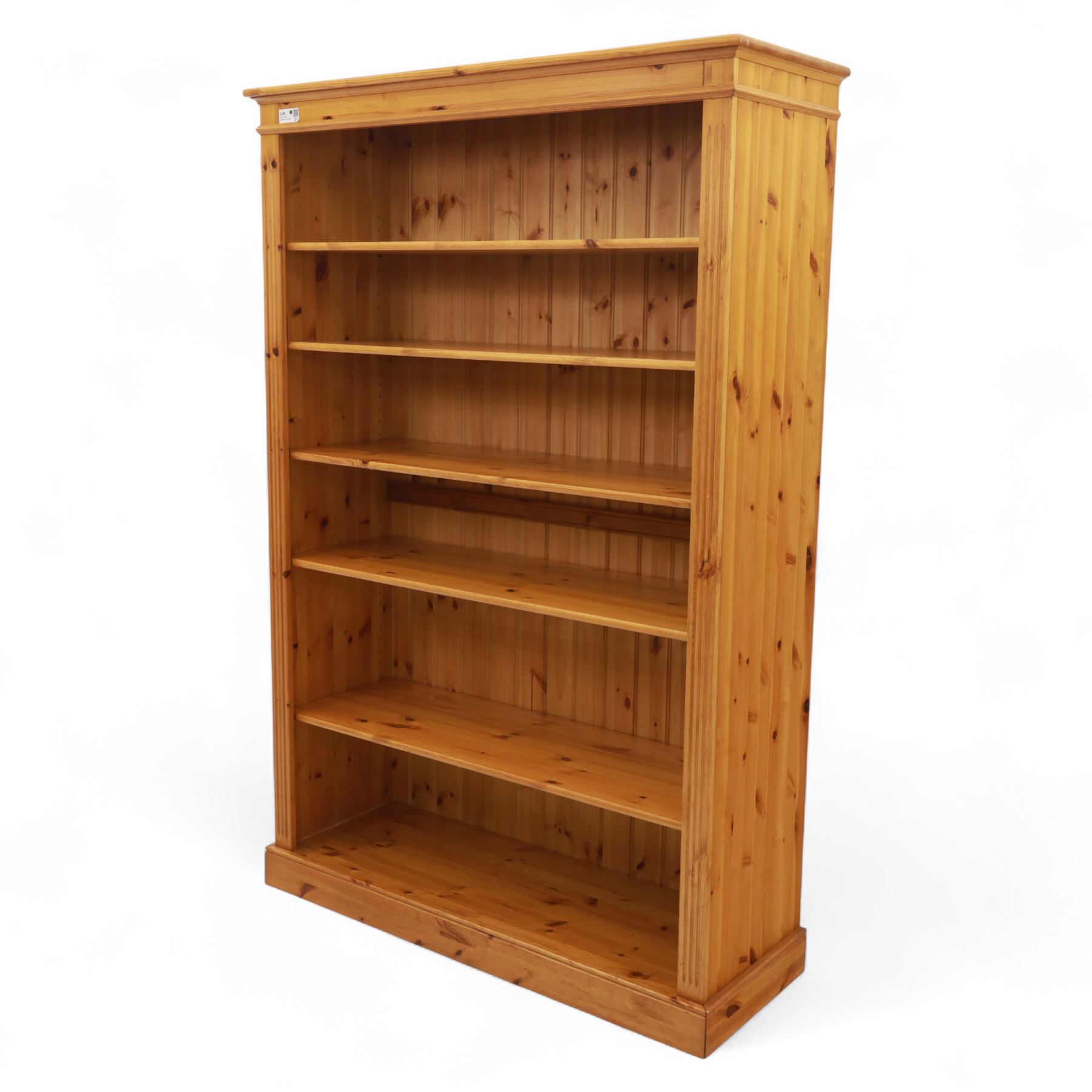 Contemporary pine open bookcase, the rectangular form with fluted uprights, tongue and groove back and five adjustable shelves