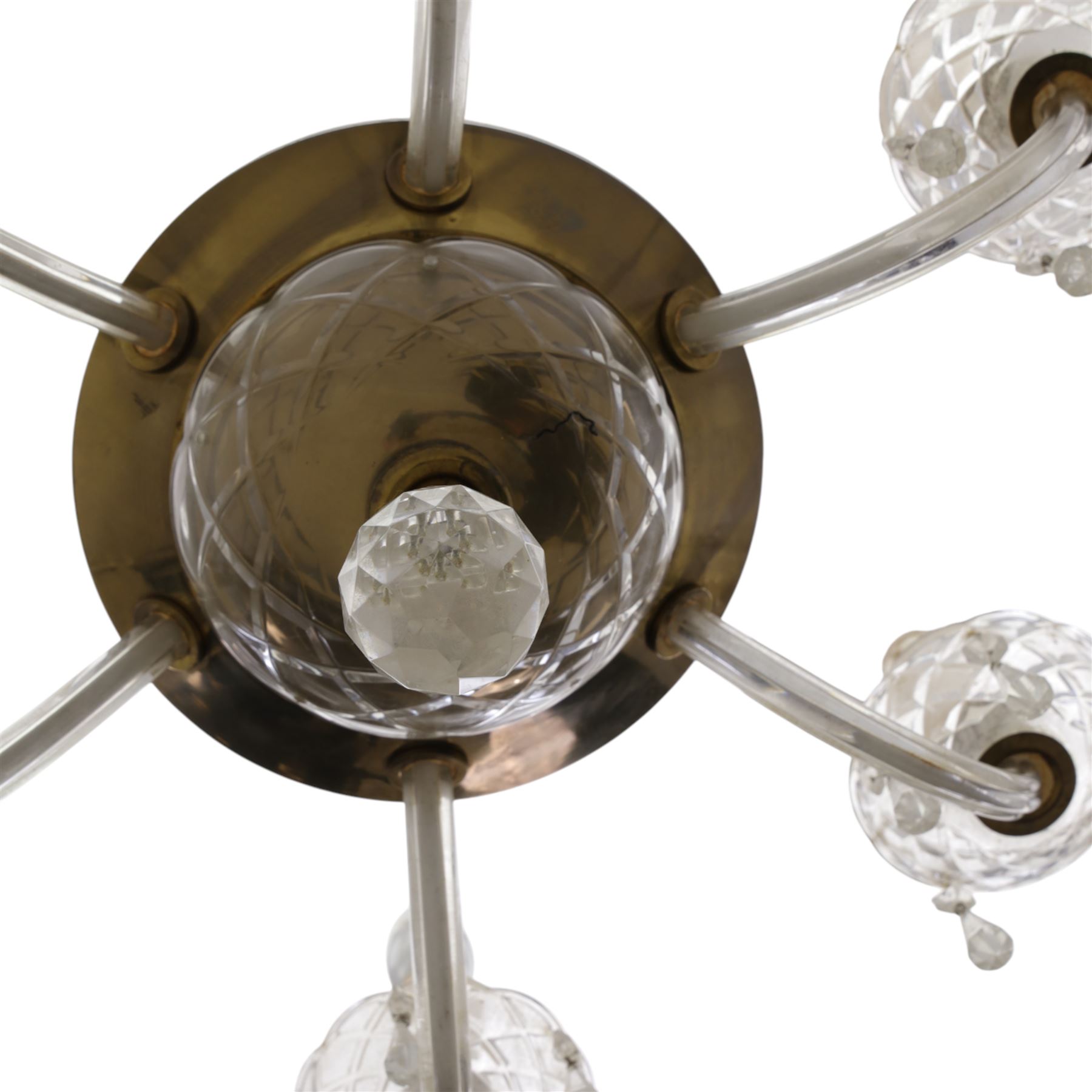 Early 20th century Continental glass and brass six branch chandelier, the central baluster column hung with graduated faceted glass drops, issuing six scrolling glass arms each fitted with candle sconces and drip pans, suspended from a fluted glass canopy