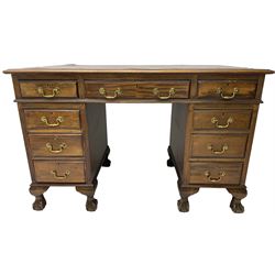 Early 20th century mahogany twin pedestal desk, fitted with nine drawers, on ball and claw carved cabriole feet