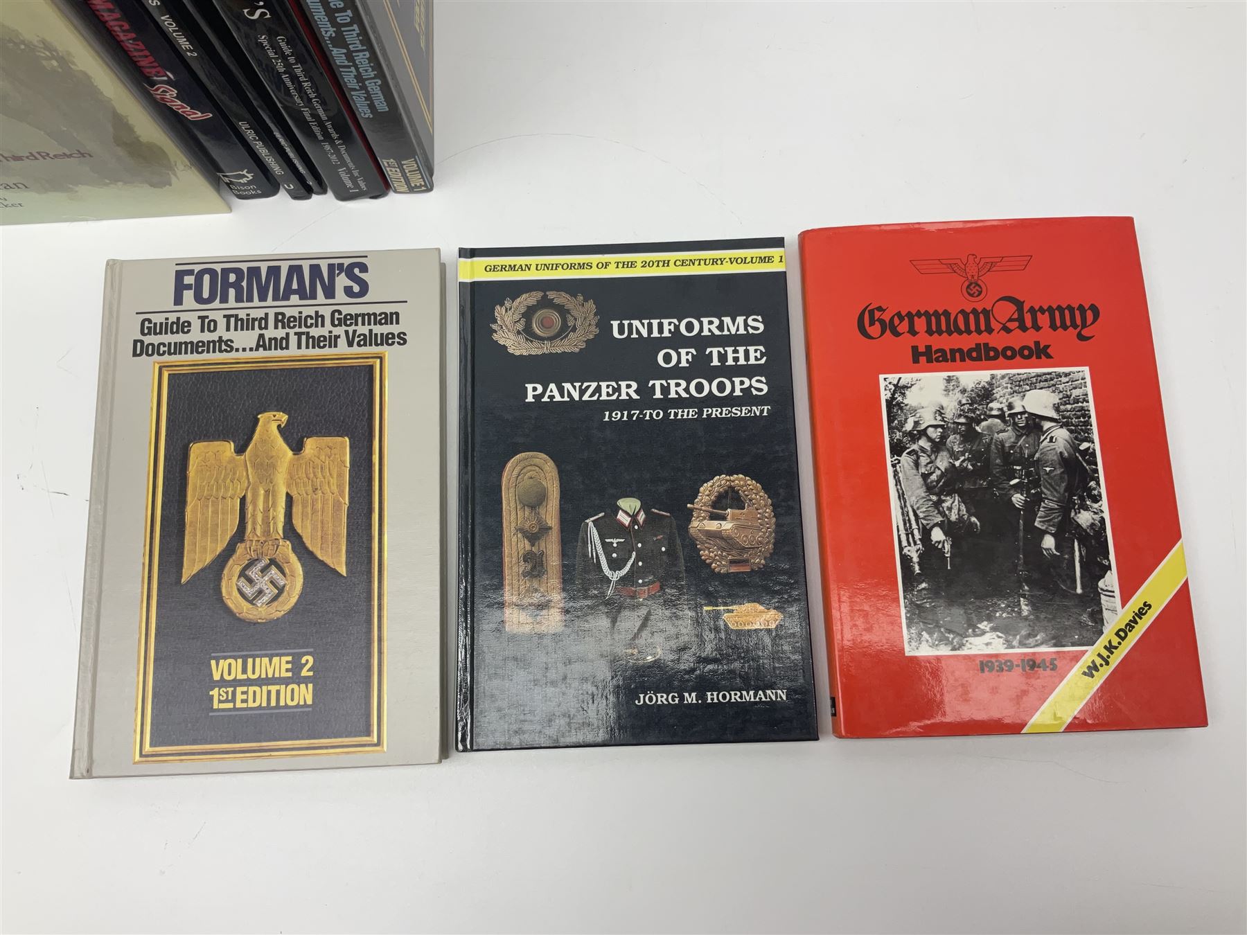 Excellent collection of twelve German Third Reich reference books including four by Adrian Forman - Guide to Third Reich German Awards and Documents, ........ Documents and Their Values. Volumes one and two. Both limited edition and signed by the author; and Bravery, Courage & Valour - Decorations and Awards of the Third Reich; D.E. Bowen: The Prussian & German iron Cross. Signed by the author; Ulric of England: Collecting Third Reich 'SS' and Political Cuffbands. Two volumes; Don Boyle: 'SS' Totenkopf H. Himmler Ring 1933-1945. 2nd printing. Signed by the author and inscribed to 'Adrian' (Forman); and four others (12)