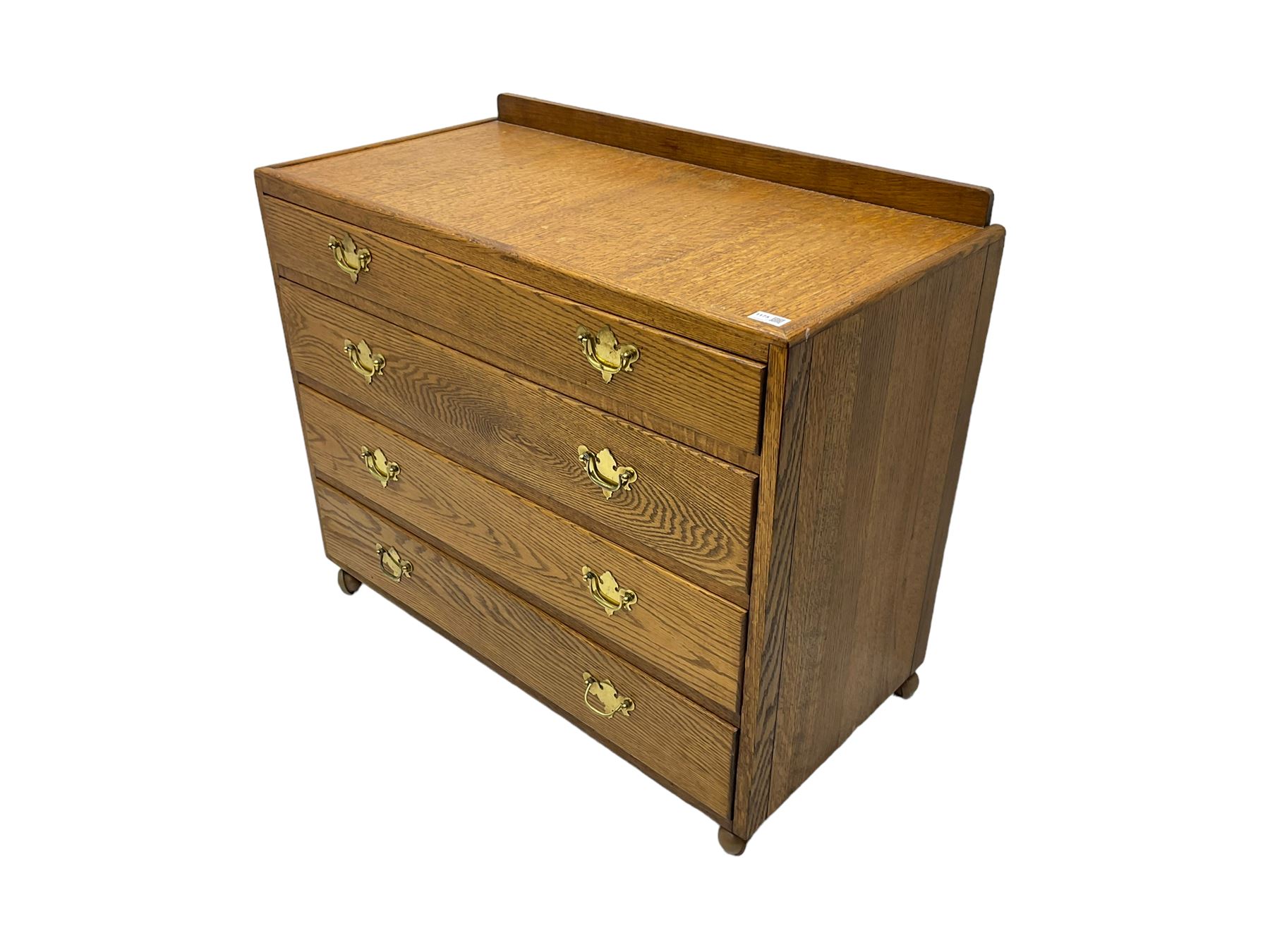 Mid-20th century oak chest, raised back, fitted with four graduating drawers, on castors