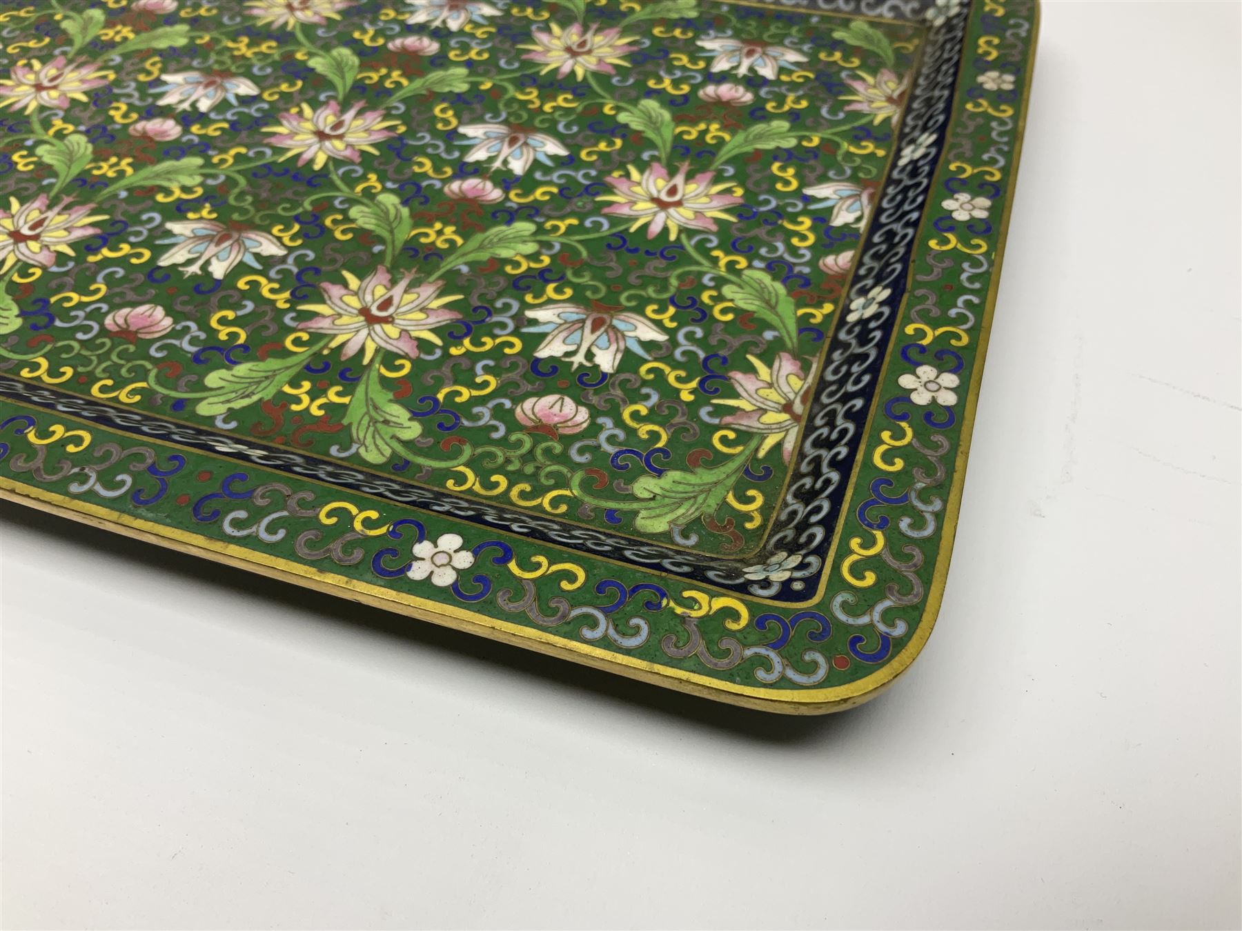 20th century Chinese cloisonne enamel smoking set, comprising two ashtrays, box and tray, with floral and foliate scrolling on green ground