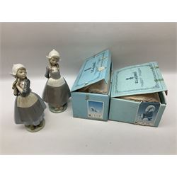 Two Lladro figures, Dutch Girl with Braids no 5063 and Dutch Girl Kristina no 5062 together with two Lladro Gres figures Fernando no 12167 and Julio no 12168, two with original boxes, largest example H25cm