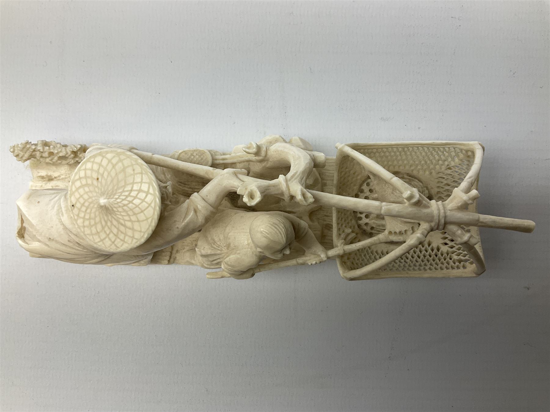 Japanese Tokyo School one piece ivory okimono, 19th century, carved as two fisherman with a net, H6cm, L15.5cm
