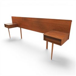 Austinsuite - mid 20th century teak headboard with bedside cabinets and matching  mirrored dressing table, the headboard with floating single drawer bedsides raised on a single tapering support, the dressing table with attached tilting mirror, above rectangular top with kneehole and two banks of two drawers, raised on tapering supports

Headboard H 84cm, D 40cm, W 229cm, W between bedsides 151cm 
Dressing table H 113cm D 44cm, W 149cm, H to underside of dresser 61cm
