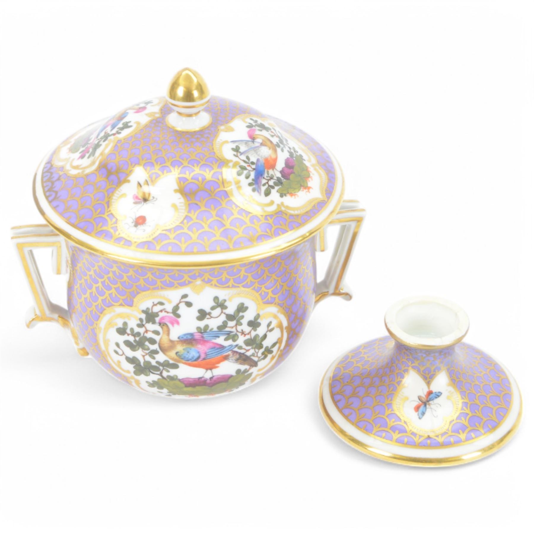 19th century twin handled cup and cover, the pedestal cup decorated with panels of exotic plumed birds in the manner of Giles, against a purple and gilt scale ground, the cover similarly decorated, H19cm