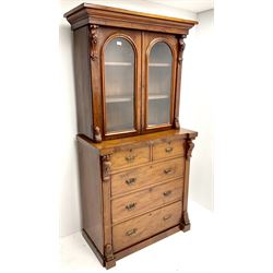 Victorian mahogany bookcase on cupboard, projecting cornice above two glazed doors, two short and three long drawers, platform base