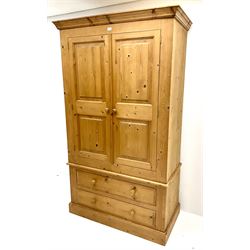 Pine double wardrobe, projecting cornice, two doors above two drawers, plinth base