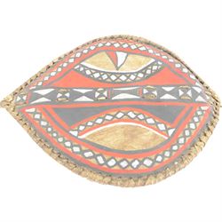 Maasai shield, made of hide, with white, red and black pigment decoration, the back attached to a wooden frame with hide stitching, together with two Maasai spears, shield H70cm, spears L120cm