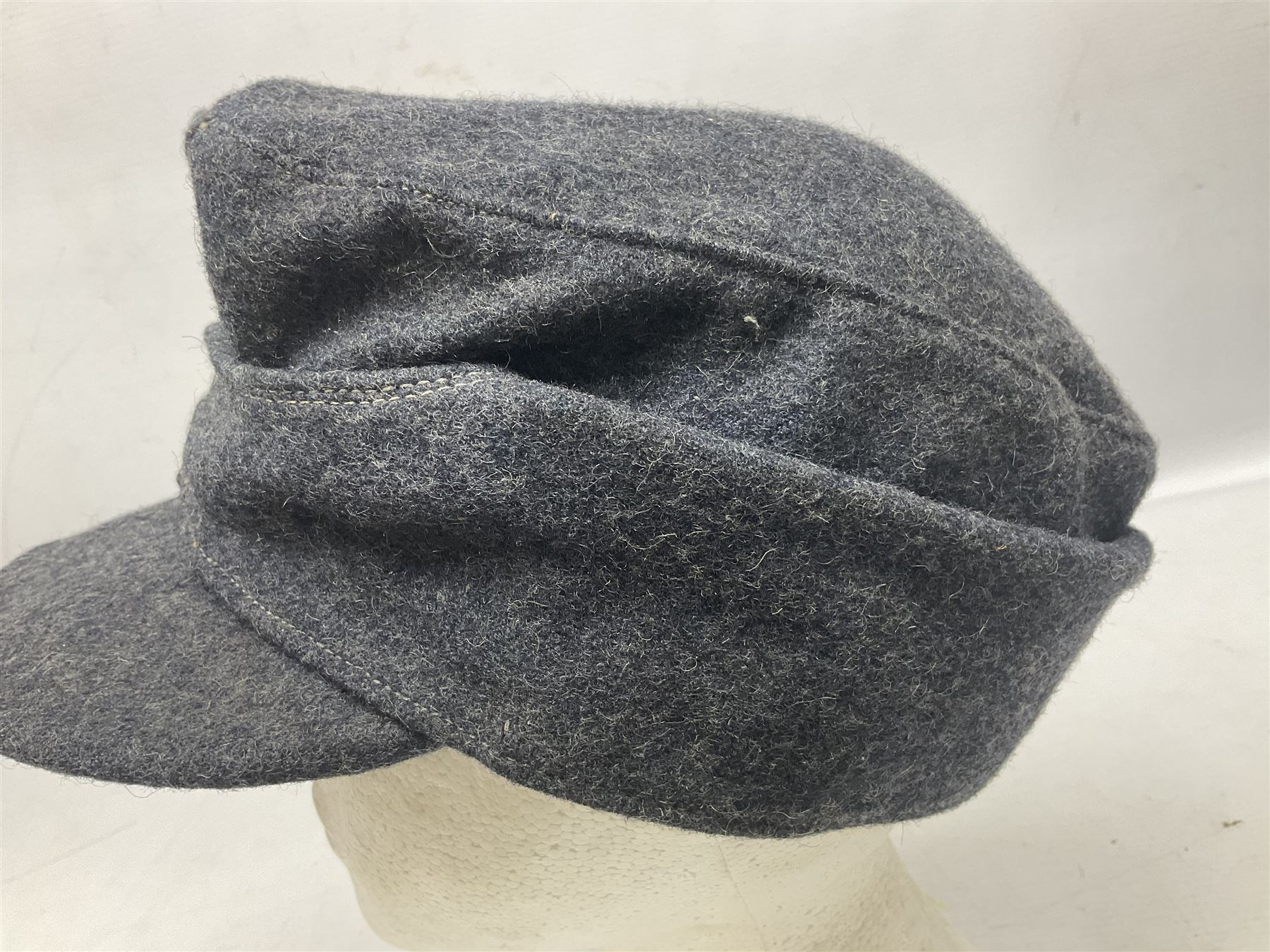 WW2 German Luftwaffe M43 field cap with triangular cloth eagle and roundel badge; marked '1944 ?/0501/0015 57'