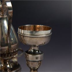 Ecclesiastical silver cruets, comprising two jugs in the form of miniature wine carafes, one hallmarked London 1825, the other unmarked, contained in a silver cruet stand with loop handle, hallmarked London 1937, and a French silver jar and cover in the form of a miniature chalice, with Minerva's head standard mark, tallest H13cm