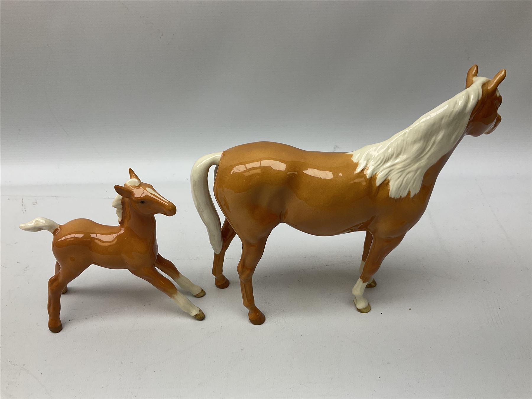 Collection of Beswick horses, including grey horse no.701, palomino foal no 836, grey stocky jogging mare no.855 etc, together two Royal Doulton horses, (8)