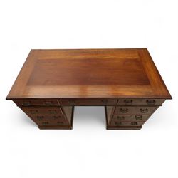 Early 20th century Indian hardwood pedestal desk, rectangular top with moulded edge over three frieze drawers, twin pedestals each fitted with four drawers, brass pierced swing handles and brass escutcheons, upon plinth bases  