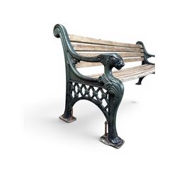 Neoclassical design cast iron and oak slatted garden bench, the twin end supports in the form of a Sphinx with acanthus carved knees and large paw feet, the pierced lattice bracket with Yorkshire rose motifs