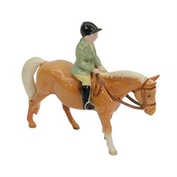 Two Beswick figures, comprising Boy on palomino pony no 1500 and Thelwell Angel on Horseback