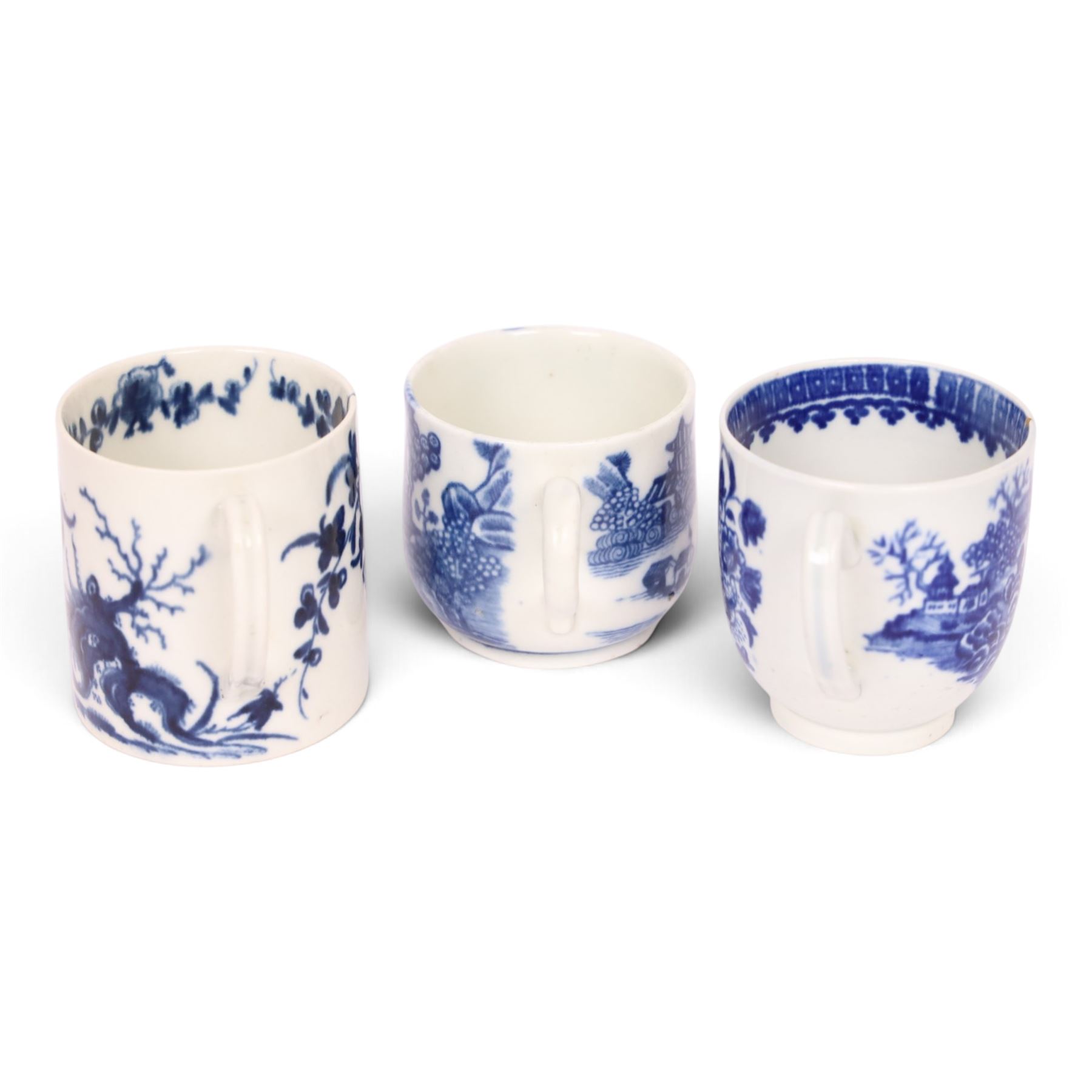 Worcester blue and white coffee cup, decorated in the Fisherman or Pleasure Boat pattern, circa 1775, together with a Worcester blue and white coffee can, decorated in the Prunus pattern, circa 1770-1775, and a Caughley blue and white custard cup, decorated in the Willow Nankin pattern, circa 1784-1792, each with marks beneath, custard cup H5.5cm