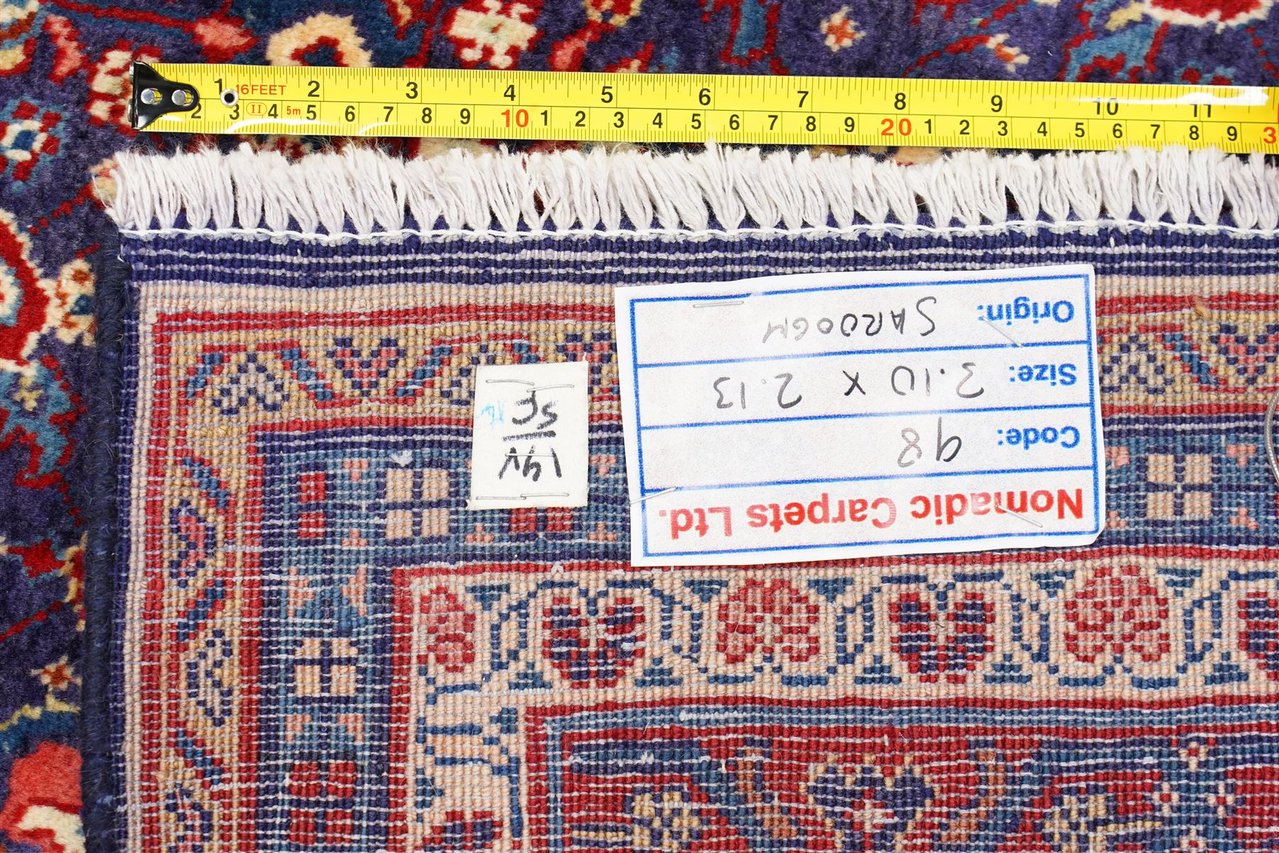 West Persian Mahal hand-knotted carpet, indigo field with central stylized angular medallion issuing an all-over Herati-inspired lattice of floral sprays, rosettes and geometric vinery in tone soft madder red, ivory and soft blue, principal border decorated with stylized palmettes, and angular vine motifs, flanked by multiple guard borders, with cotton fringe ends 