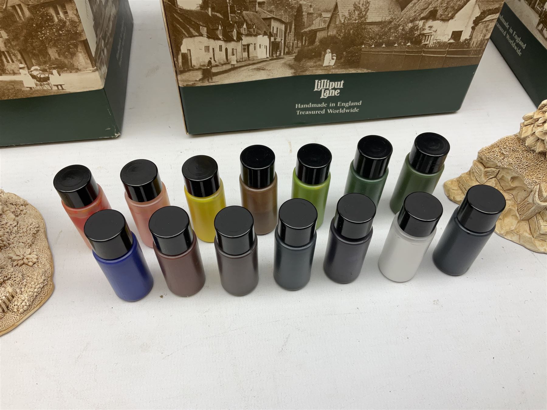 Ten Lilliput Lane models from the 'Paint Your Own' collection, to include cottages and plaques, all boxed, to include one boxed model with paints and brushes and a further box of paints