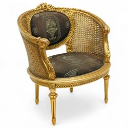 Louis XVI design tub armchair, studded upholstered padded back and seat with double cane side panels on fluted legs 