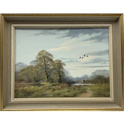 John Caesar Smith (British 1930-): Wooded Landscape with Geese in Flight, oil on canvas signed 29cm x 39cm
