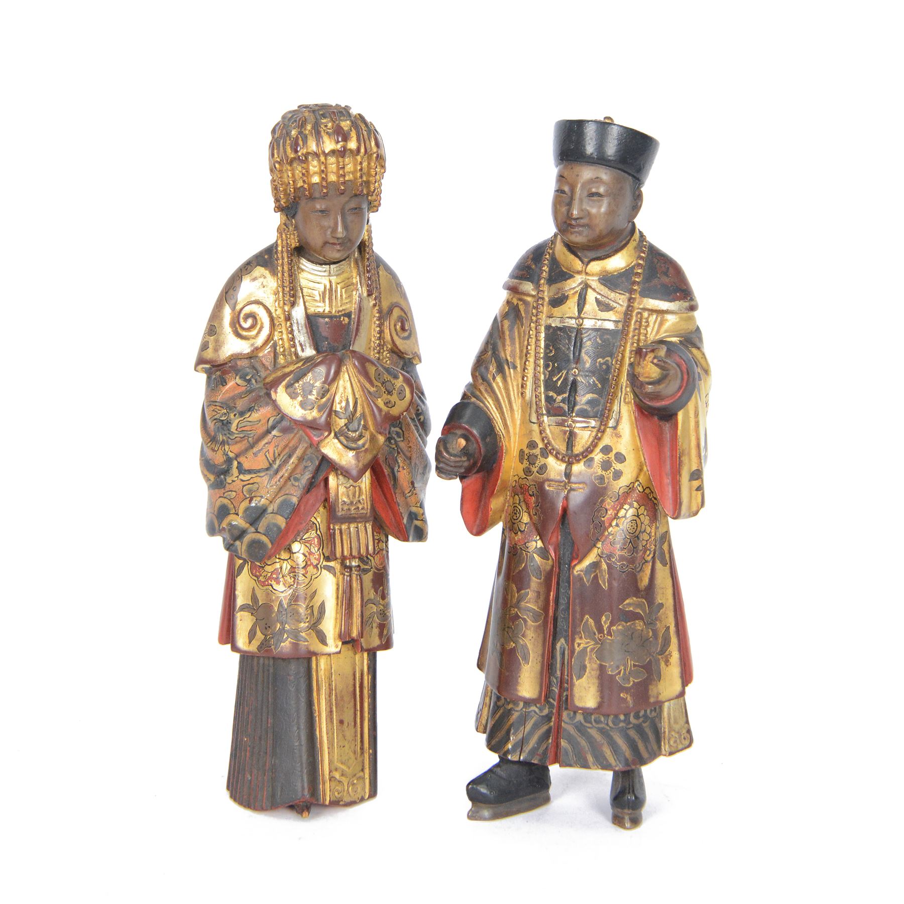 Pair of Asian carved wooden lacquered figures, in ceremonial dress, possibly wedding attire, highlighted throughout in gilt, H22cm