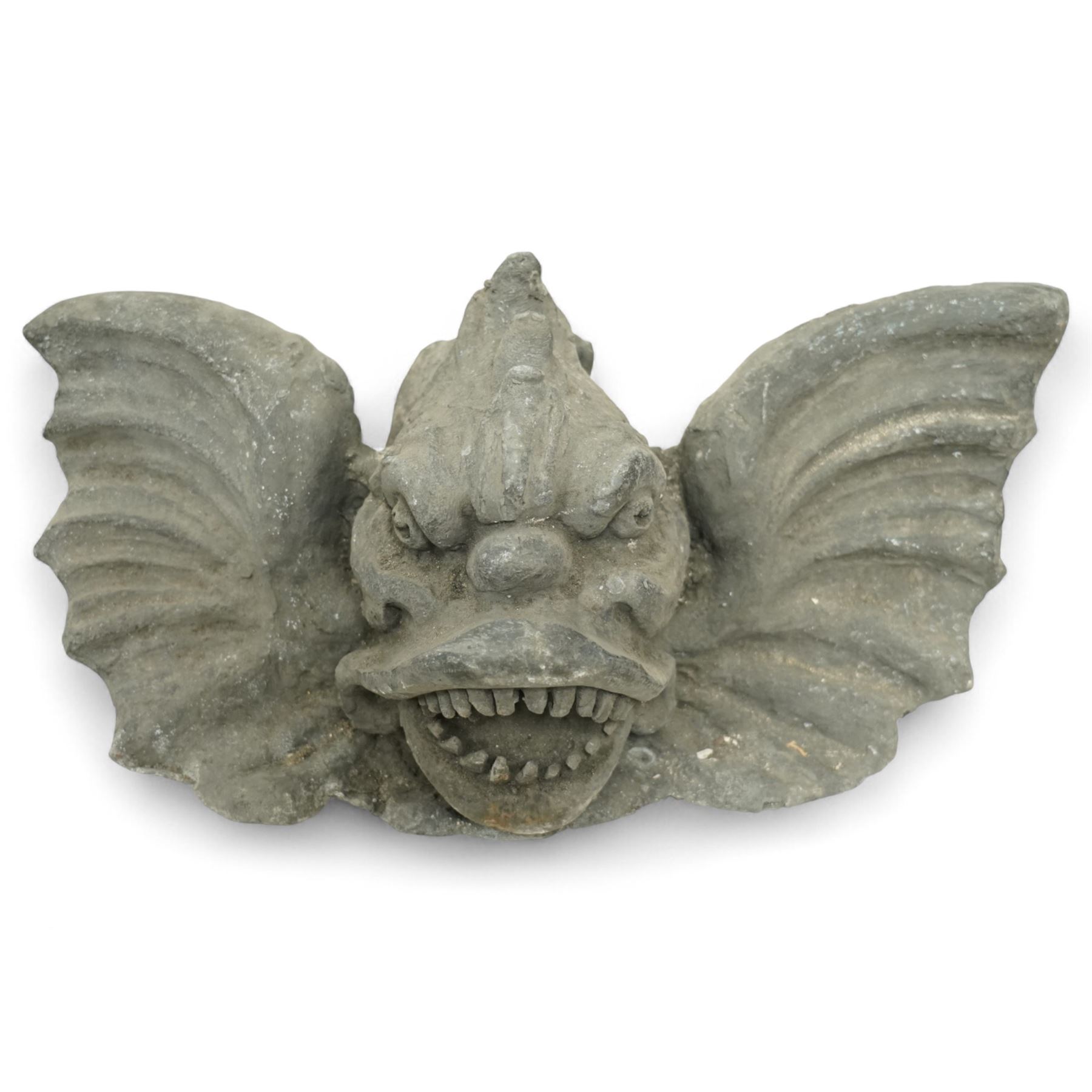 19th century cast lead fountain head with spout in the form of a grotesque fish, the mouth agape with rows of teeth, flanked by protruding fins 