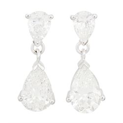 Pair of 18ct white gold two stone pear cut diamond pendant stud earrings, hallmarked, the ...