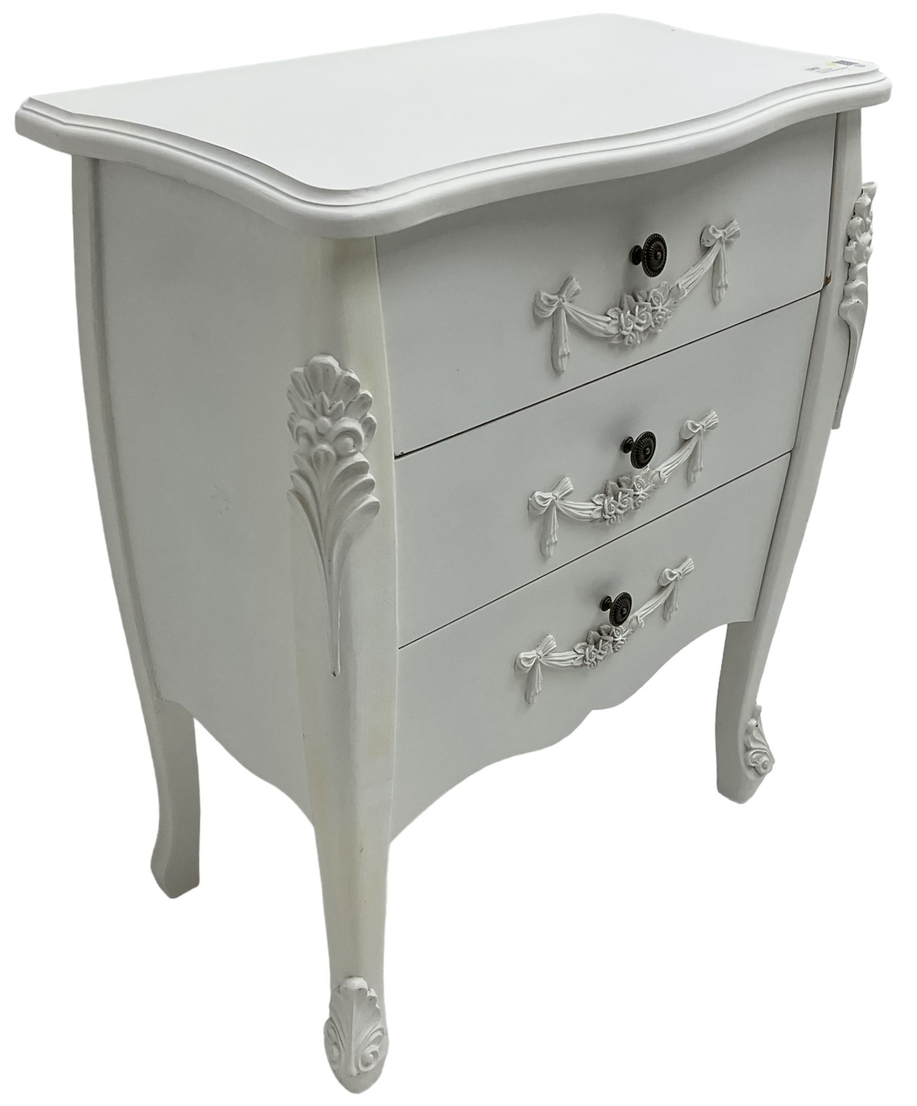 French design white painted chest, shaped top over three drawers, each with applied swags with flower heads, flanked by cabriole uprights with foliate mouldings