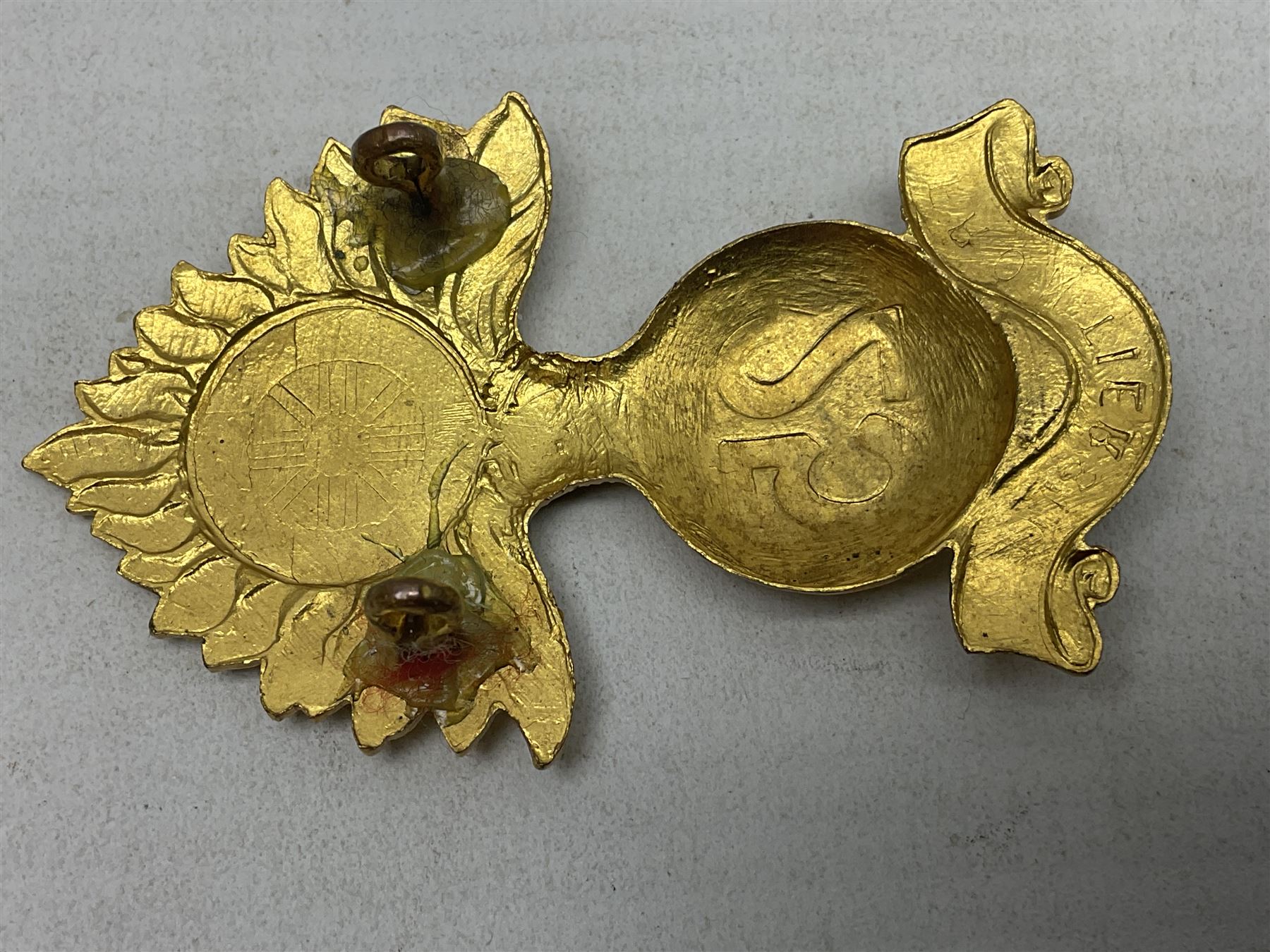 WW1 25th Battalion (Frontiersmen) City of London Royal Fusiliers Cap Badge; gilt brass fused grenade with 25 to the centre; circular section to the flames with red enamel cross and enamel union flag with GOD GUARD THEE to the centre; lower scroll with FRONTIERSMEN; two lug fittings verso.