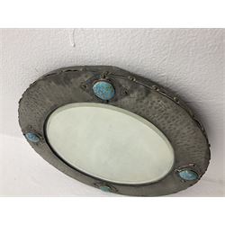 Arts & Crafts style circular hammered pewter mirror inset with four turquoise cabochons, D27.5cm