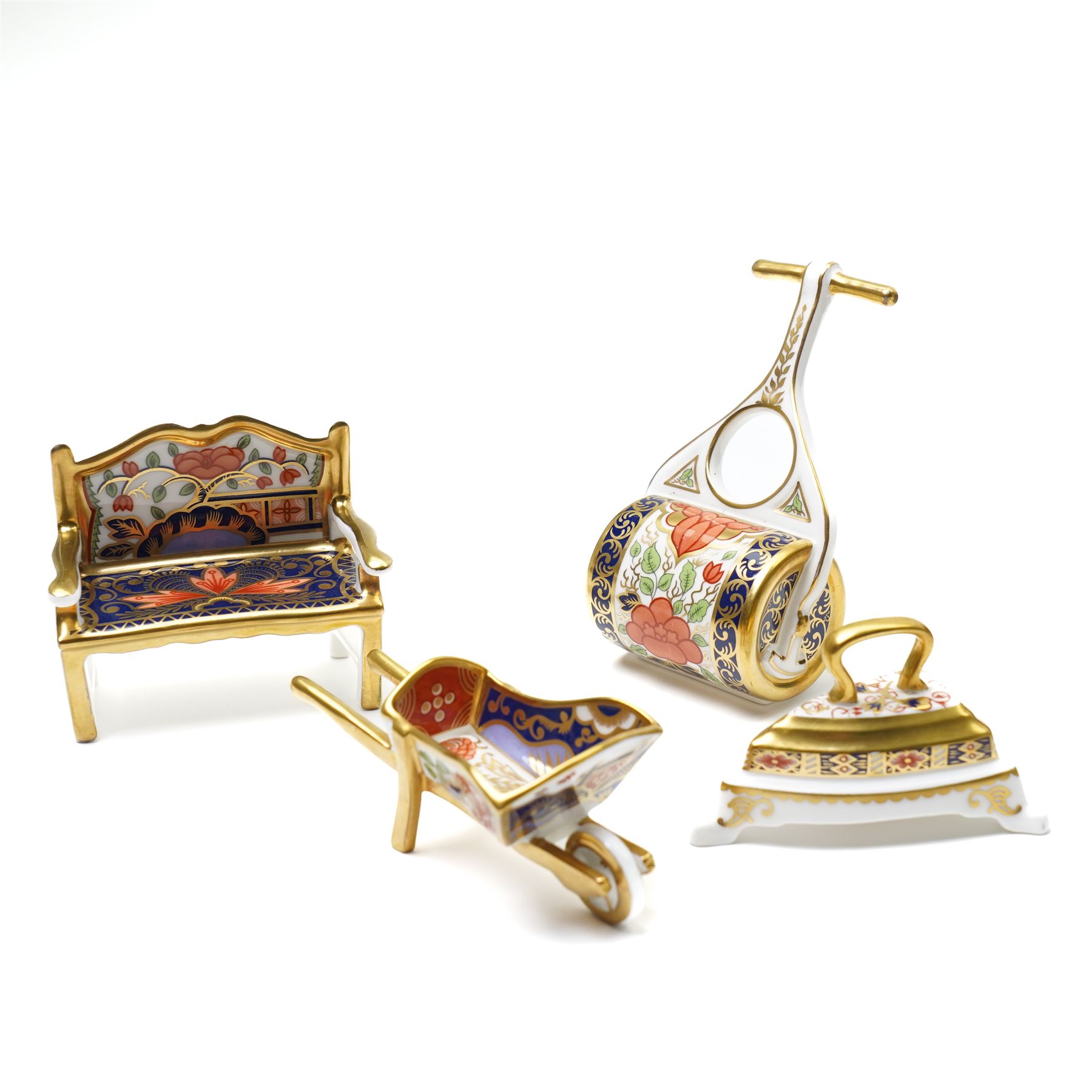 Collection of Royal Crown Derby miniature wares in Imari type patterns, comprising two champagne buckets with miniature champagne, milk churn, kettle, watering can, lawn roller, wheelbarrow, bench and kettle, five with boxes (10)