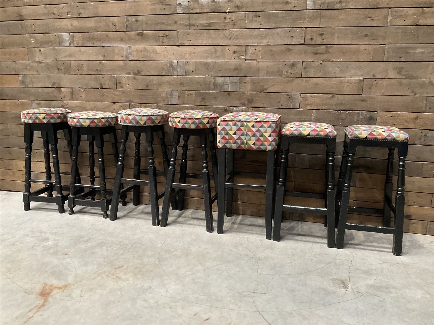 Seven tall bar stools with upholstered seat