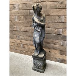 Cast stone weathered garden statue of Venus on pedestal