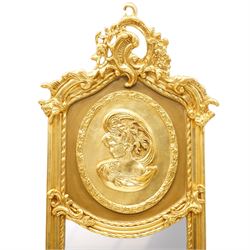 Pair of Rococo Revival gilt framed wall mirrors, the pierced scrolling rocaille pediment with foliate motifs over an oval panel with relief portraits of classically draped females, over a shaped rectangular bevelled plate surrounded by beading and scrolling foliate motifs