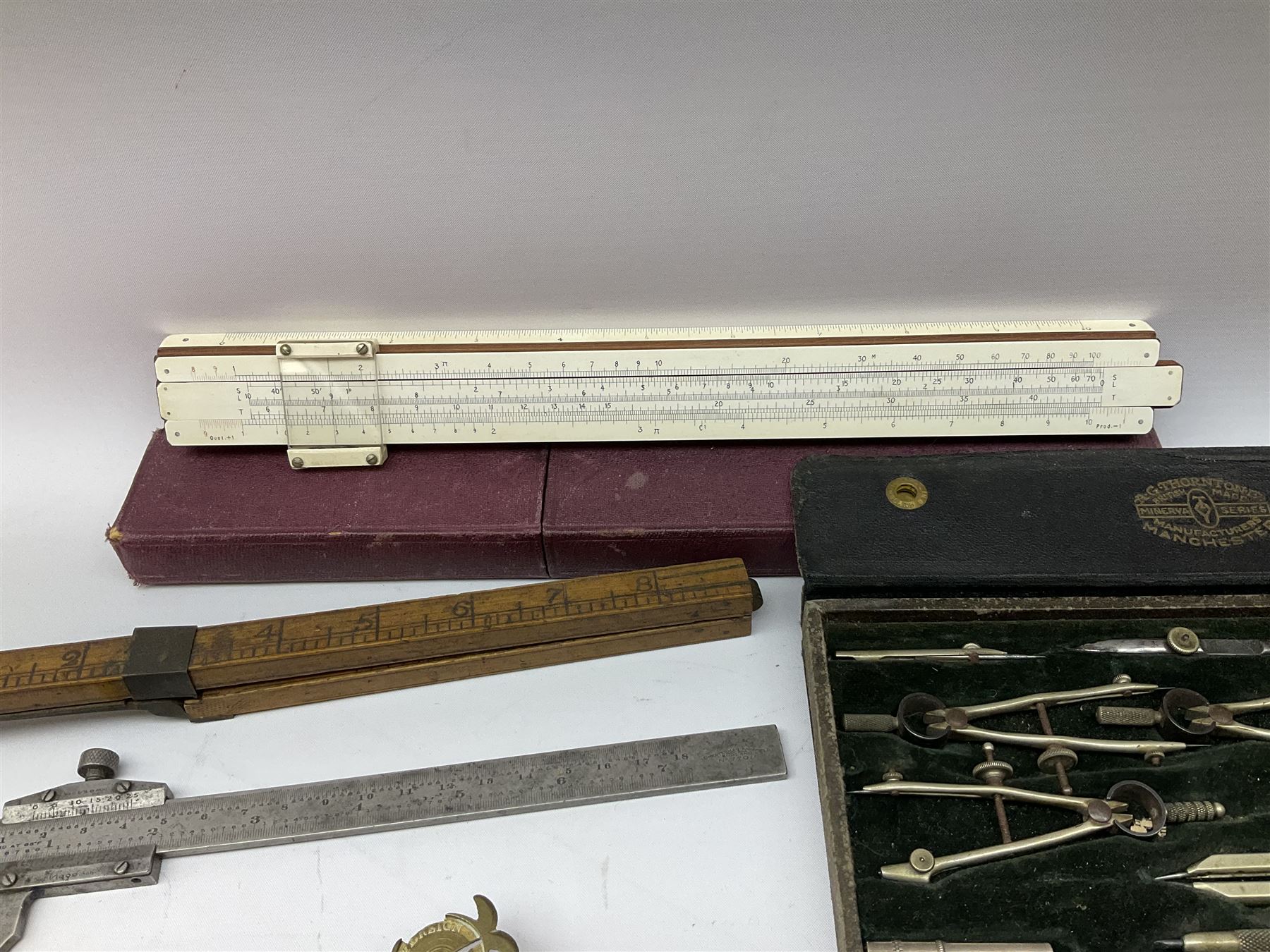 Two Victorian brass sovereign scales, one marked 'Harrison' L10cm; cased set of drawing instruments by G. Thornton Limited Manchester; Chesterman No.770/1 steel vernier caliper; two boxwood rulers; cased slide rule; brass and boxwood rope/wire gauge etc