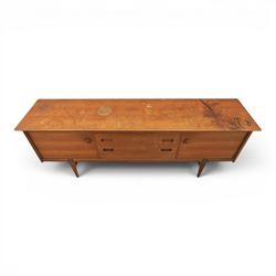 John Herbert for Youngers - 'Fonseca' mid-century teak sideboard, rectangular top above a central bank of three drawers one fitted for cutlery, flanked by cupboards with fixed shelved interior, raised on tapering supports 